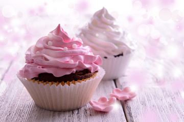 Delicious cupcakes on table on festive background