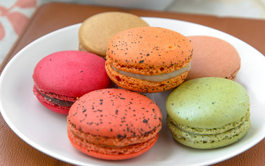sweet colourful macarons in the white plate