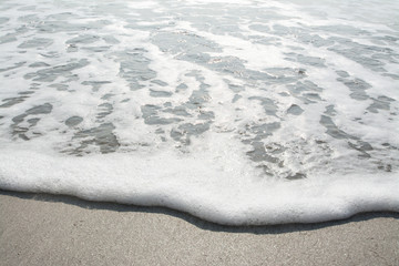 Wave of the sea on the sand beach 