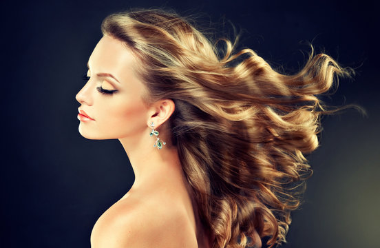 Fototapeta Beautiful model blond with curly hair and fashion earings