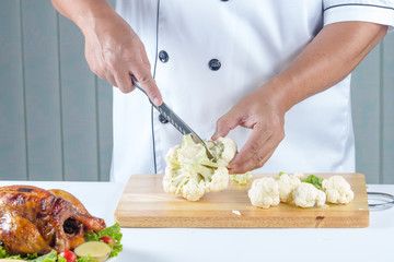chef cutting cauliflower