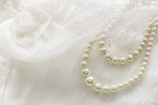 Pearl necklace on lace background.