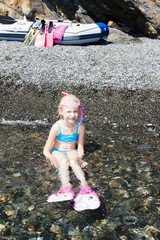 little girl on the beach at sea ready for snorkeling