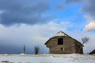 Old wooden barn in the countryside, in the winter