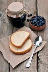 Bread and blueberry jam in glass jar