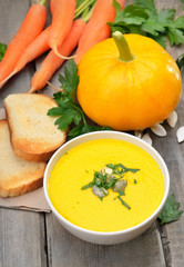 Pumpkin soup on wooden table