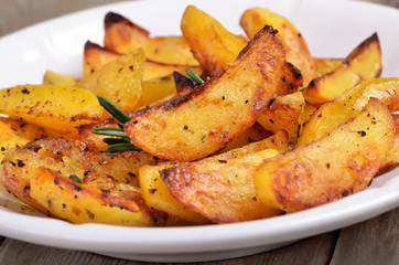 Fried potato wedges on white plate