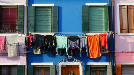 laundry in front of colorful houses