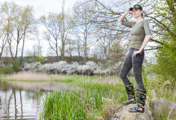 woman wearing rubber boots in spring nature