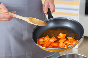Closeup of pan with ravioli and tomato