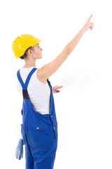 back view of woman builder in blue coveralls holding building sc
