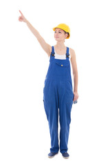 young woman builder pointing at something isolated on white
