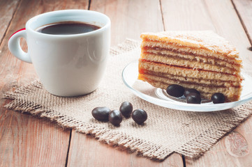 coffee, cake and peanuts on the wood background