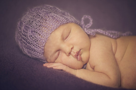 Close Up Of Newborn Baby In Hat Made Of Wool