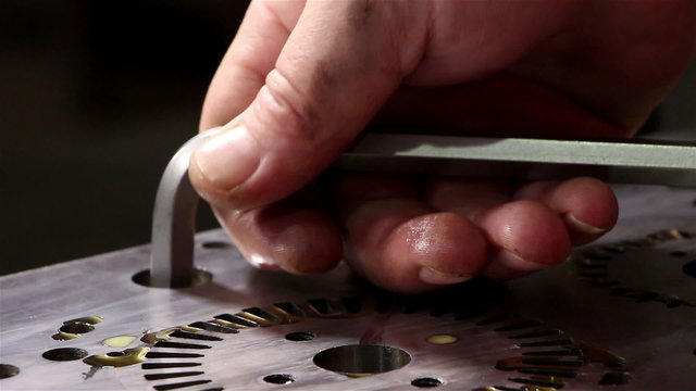 Heavy industry - Man tightening a bolt or screw using a socket