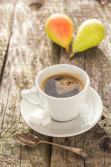 coffee cup black wooden board brown pears white