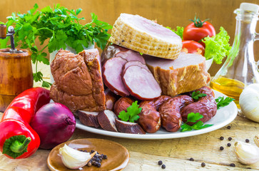 plate various kinds sausages surrounded greens