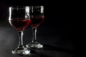 Two Glasses of Red Wine Isolated on Black Background