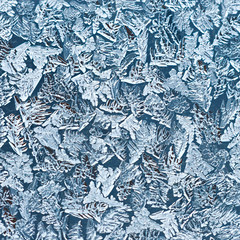 Frozen water on the glass surface. Abstract pattern on winter windows