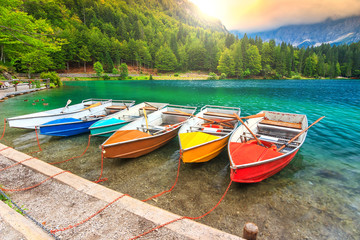 Fototapeta na wymiar Wonderful alpine landscape and colorful boats,Lake Fusine,Italy
