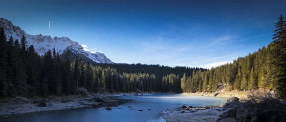 Fototapeta na wymiar Carezza lake in winter with frosty surface