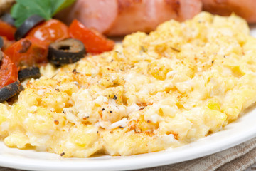 scramble eggs with tomatoes, sausage and toast, close-up
