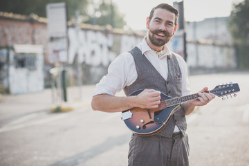 handsome big moustache hipster man playing mandolin