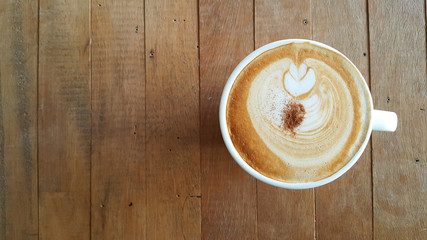 Fresh coffee on the table, Coffee cup top view on old wooden
