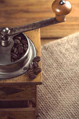 top view over old manual coffee grinder on wooden table