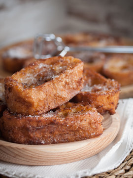 French toasts on a wooden plate.