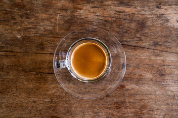 Obraz na płótnie Canvas Cup of hot espresso coffee on wooden table.