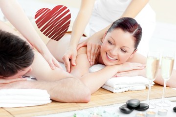 Obraz na płótnie Canvas Composite image of positive young couple enjoying a back massage