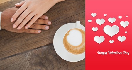 Composite image of couple holding hands beside cappuccino