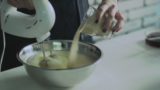 Mixing  egg cream in bowl with motor mixer, baking cake