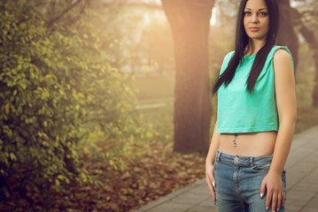 Young girl posing with navel piercing