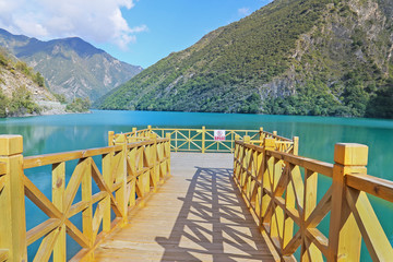 wooden platform before lake  with mountain
