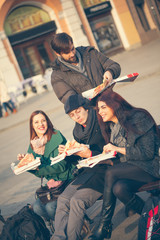 Fototapeta na wymiar Group Of Friends Eating Pizza Outdoors