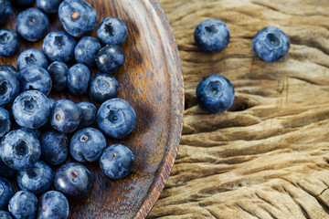 Blueberries in a bowl on a wooden table.