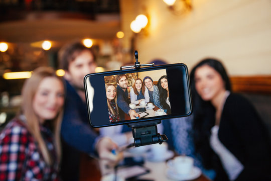 Group Of Friends In Cafe Taking Selfie