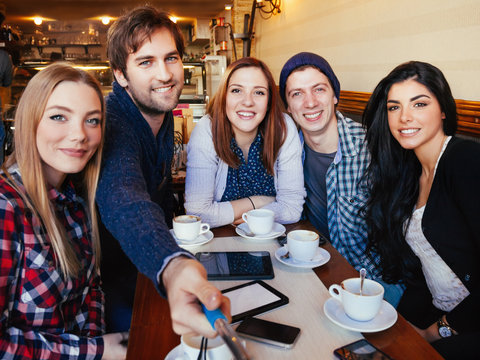 Group Of Friends In Cafe Taking Selfie