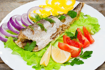 fish hake baked with vegetables on a plate