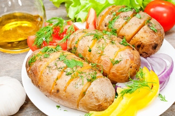 baked potato on a plate with vegetables
