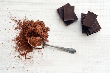 Chocolate bars with heap of cacao powder