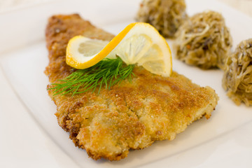 Fried fillet with cabbage and mushrooms
