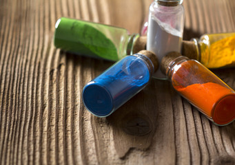 Glass bottles filled with coloured powder
