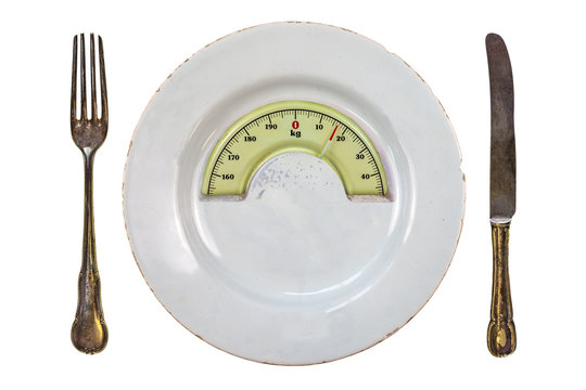 Plate with a weight balance scale. Diet concept