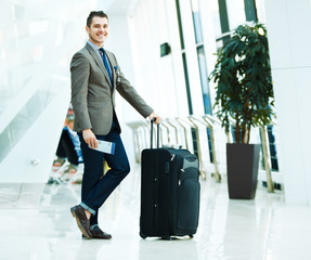 businessman with luggage in airport