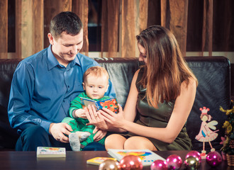 Naklejka premium parents showing book to little son