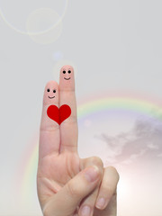 Fingers in love over sky