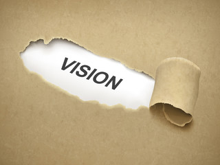 the word vision behind torn paper